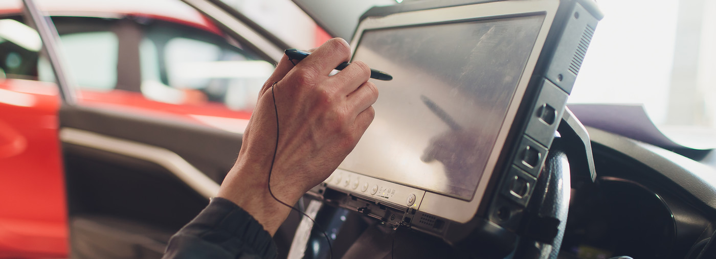 Mechanic using diagnostic equipment to check over a vehicle issue - Car Diagnostics Soham, Ely